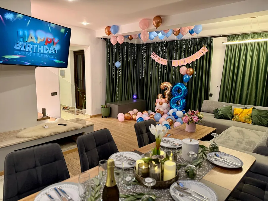 Birthday party in the living room — balloons and a Happy Birthday message on TV